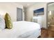 Comfortable bedroom features a TV, a large bed, and an ensuite bathroom at 1539 Corolla Ct, Reunion, FL 34747