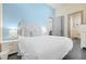 Comfortable bedroom featuring a queen bed, stylish lamps, attached bathroom, and a bright blue accent wall at 1539 Corolla Ct, Reunion, FL 34747