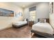 Charming bedroom featuring two twin beds, stylish decor, and a large window, providing lots of natural light at 1539 Corolla Ct, Reunion, FL 34747