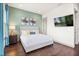 Comfortable bedroom featuring a queen bed, accent wall, and TV, creating a relaxing and inviting space at 1539 Corolla Ct, Reunion, FL 34747