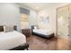 Comfortable bedroom featuring two twin beds, wooden floors, and an en suite bathroom with glass shower at 1539 Corolla Ct, Reunion, FL 34747