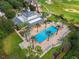 Aerial view of the community pool and recreation area surrounded by palm trees and golf course at 1539 Corolla Ct, Reunion, FL 34747
