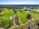 Stunning aerial view of the lush golf course winding through the community, complete with lakes and manicured greens at 1539 Corolla Ct, Reunion, FL 34747