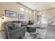 Living room featuring a gray sectional sofa, ottoman, and a stylish rug at 1539 Corolla Ct, Reunion, FL 34747
