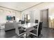 Open-concept living and dining area offers stylish seating and a modern dining table at 1539 Corolla Ct, Reunion, FL 34747