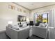 Bright living room features contemporary furniture, a large TV, and outdoor views at 1539 Corolla Ct, Reunion, FL 34747