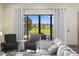 Elegant living room with plush seating, stylish decor, and a view of the pool area at 1539 Corolla Ct, Reunion, FL 34747
