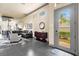 Open-concept living room with modern decor, high ceilings, and access to the outdoors at 1539 Corolla Ct, Reunion, FL 34747