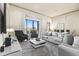 Well-lit living room boasts modern furnishings, sleek design, and comfortable seating at 1539 Corolla Ct, Reunion, FL 34747