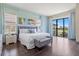 Bright bedroom featuring a king-size bed and balcony overlooking a golf course at 1539 Corolla Ct, Reunion, FL 34747