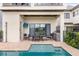 A covered patio with a ceiling fan overlooks the pool, dining area, and outdoor kitchen at 1539 Corolla Ct, Reunion, FL 34747