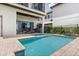 A beautiful backyard pool offers an outdoor kitchen and dining area for entertaining at 1539 Corolla Ct, Reunion, FL 34747