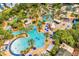 Expansive pool area with palm trees, lounge chairs, and multiple pools offering a luxurious resort experience at 1539 Corolla Ct, Reunion, FL 34747