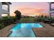 A serene pool offers a relaxing outdoor space with beautiful views and a lounge area at 1539 Corolla Ct, Reunion, FL 34747