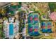 Aerial view showcasing the community's recreational amenities, including swimming pool, tennis courts, and miniature golf at 1539 Corolla Ct, Reunion, FL 34747