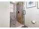 Modern shower stall featuring neutral tilework, a frameless glass door, and contemporary fixtures at 1539 Corolla Ct, Reunion, FL 34747