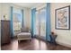 Cozy sitting area with a comfortable chair, chest of drawers, framed art, and a small table by the door at 1539 Corolla Ct, Reunion, FL 34747