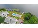 Aerial view shows lake access, community pool, parking, and condo property at 1550 11Th Ne St # H-4, Winter Haven, FL 33881