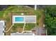 Aerial of community pool near lake with lounge chairs and lakeside access, close to parking at 1550 11Th Ne St # H-4, Winter Haven, FL 33881