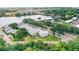 An aerial view of condo community that features well-maintained landscaping, parking, and lakeside views at 1550 11Th Ne St # H-4, Winter Haven, FL 33881