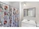 This bathroom features a floral themed shower curtain, vanity, and mirror at 1550 11Th Ne St # H-4, Winter Haven, FL 33881