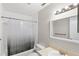 Bathroom with a shower and bath tub, toilet, vanity, and a large mirror at 1550 11Th Ne St # H-4, Winter Haven, FL 33881