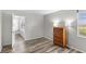 A simple bedroom with wood-look floors and neutral paint, creating a serene and relaxing space at 1550 11Th Ne St # H-4, Winter Haven, FL 33881