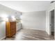 A cozy bedroom with wood-look floors, neutral paint, a closet, and plenty of sunlight from a window at 1550 11Th Ne St # H-4, Winter Haven, FL 33881
