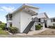 Exterior view showing a two-story condo with stair access to the upper unit and screened porch at 1550 11Th Ne St # H-4, Winter Haven, FL 33881