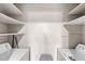 Bright laundry room features a washer and dryer, as well as built-in shelving at 1550 11Th Ne St # H-4, Winter Haven, FL 33881