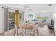 Bright living room with a ceiling fan, a dining table for four, and sliding doors to the outside at 1550 11Th Ne St # H-4, Winter Haven, FL 33881
