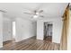 Spacious living room showcasing wood-look floors, neutral walls, and a view to the kitchen at 1550 11Th Ne St # H-4, Winter Haven, FL 33881