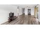 Spacious living room featuring wood-look flooring, neutral paint, and open access to the rest of the home at 1550 11Th Ne St # H-4, Winter Haven, FL 33881
