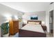 Cozy main bedroom features a comfortable bed, soft lighting, and serene decor for a relaxing retreat at 1550 11Th Ne St # H-4, Winter Haven, FL 33881