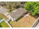 Aerial view of a well-maintained home featuring a spacious backyard with patio and mature trees offering ample shade at 1563 Dess Dr, Orlando, FL 32818