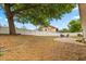 Spacious backyard with a white fence, mature tree and patio area for outdoor enjoyment at 1563 Dess Dr, Orlando, FL 32818