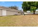Spacious backyard with green grass, patio, and a white fence for privacy and security at 1563 Dess Dr, Orlando, FL 32818