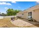 Backyard featuring a brick patio, a white fence, and a grassy area, perfect for relaxing at 1563 Dess Dr, Orlando, FL 32818