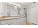 Bathroom with dual sinks, vanity, and bright lighting, and a closet for storage at 1563 Dess Dr, Orlando, FL 32818