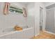 Bathroom showcasing a tiled soaking tub, and an enclosed shower for a relaxing experience at 1563 Dess Dr, Orlando, FL 32818