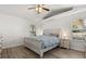Bedroom with vaulted ceiling, wood-look floors, and natural light from a large window at 1563 Dess Dr, Orlando, FL 32818
