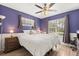Cozy bedroom with a large ceiling fan, hardwood floors, and natural light at 1563 Dess Dr, Orlando, FL 32818