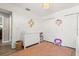Bright Bedroom features a plush rug, changing table dresser, and ample closet space at 1563 Dess Dr, Orlando, FL 32818
