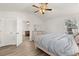 Cozy bedroom with light wood floors, neutral walls, and a large window with natural light at 1563 Dess Dr, Orlando, FL 32818