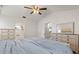 Bright bedroom featuring a ceiling fan, and matching dressers for ample storage at 1563 Dess Dr, Orlando, FL 32818