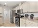 Well-lit kitchen features stainless steel appliances, light countertops, and ample cabinet space at 1563 Dess Dr, Orlando, FL 32818