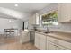 Bright kitchen featuring stainless steel sink and appliances, light cabinets and countertops, and tile flooring at 1563 Dess Dr, Orlando, FL 32818