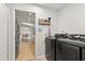 Modern laundry room featuring front loading washer and dryer with access to the kitchen at 1563 Dess Dr, Orlando, FL 32818