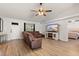 Bright living room with light wood floors, leather sofa, and modern entertainment center at 1563 Dess Dr, Orlando, FL 32818