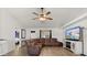 Comfortable living room featuring a leather sectional, ceiling fan, and entertainment center at 1563 Dess Dr, Orlando, FL 32818